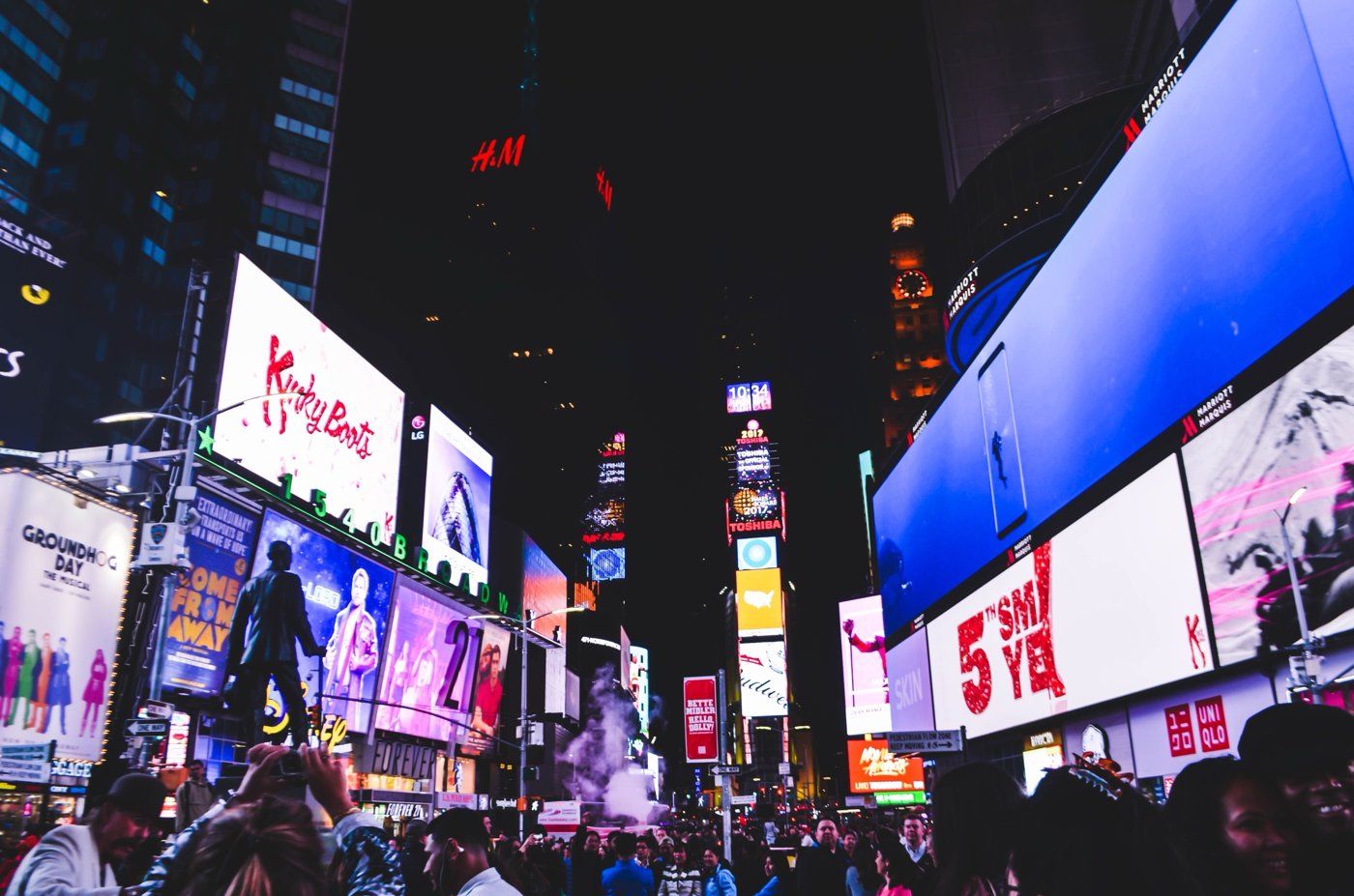 Street of large outdoor LED billboards at night